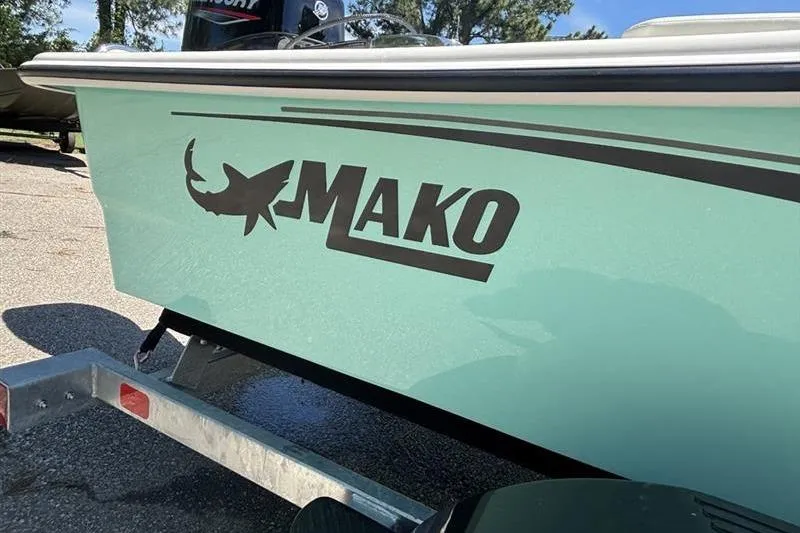 Slide: The Image of 2026 Mako Pro Skiff 15 CC boat on trailer, featuring sleek design and logo. - 7