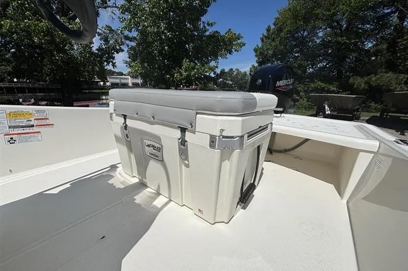 Slide: The Image of 2026 Mako Pro Skiff 15 CC boat interior with cooler seat and Mercury engine. - 8