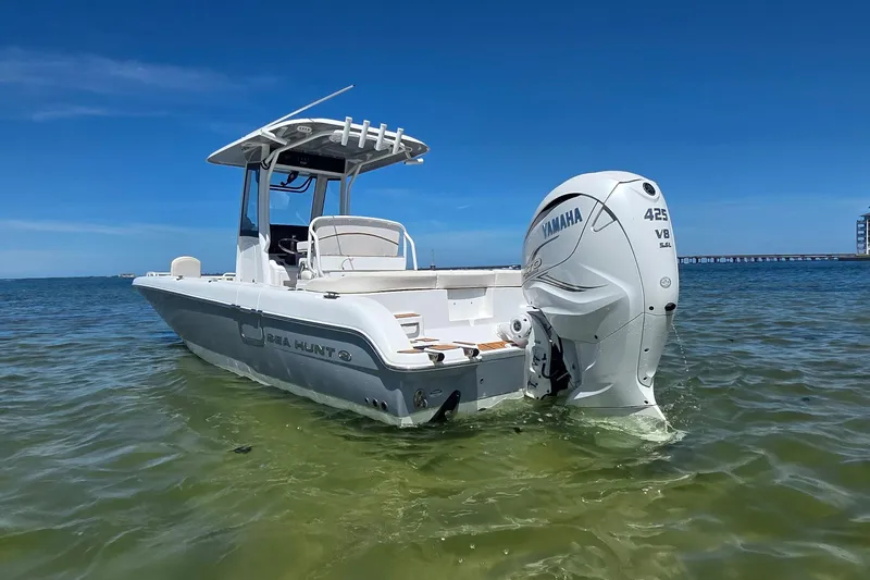 Slide: The Image of 2021 Sea Hunt Escape 27 boat with Yamaha V8 engine on clear water. - 1