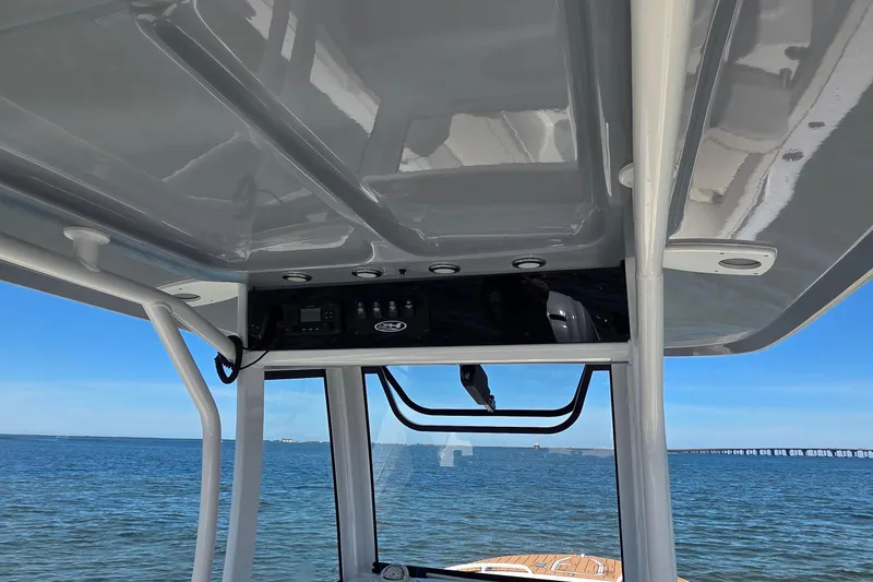 Slide: The Image of 2021 Sea Hunt Escape 27 boat interior with ocean view and control panel. - 15