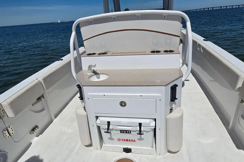 Slide: The Image of 2021 Sea Hunt Escape 27 boat interior with sink and storage, ocean view. - 17