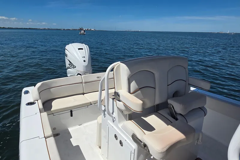 Slide: The Image of 2021 Sea Hunt Escape 27 boat interior with seating and outboard motor on open water. - 18