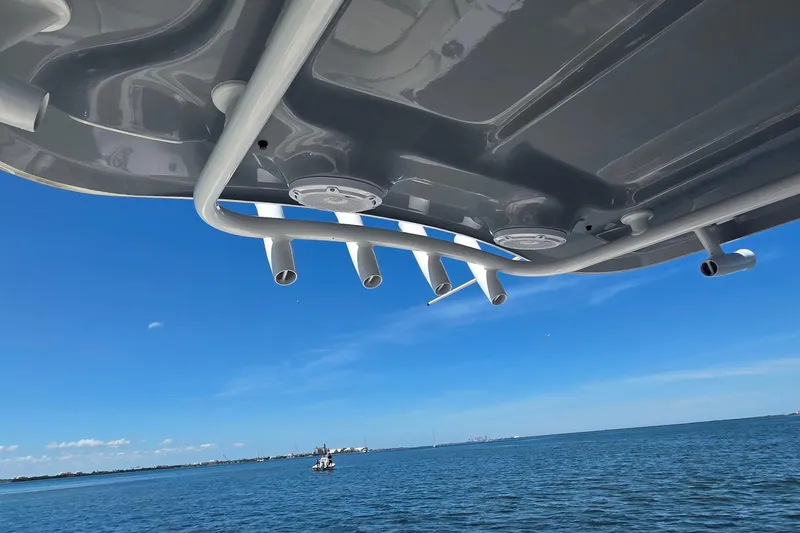 Slide: The Image of 2021 Sea Hunt Escape 27 boat canopy with rod holders over ocean. - 19