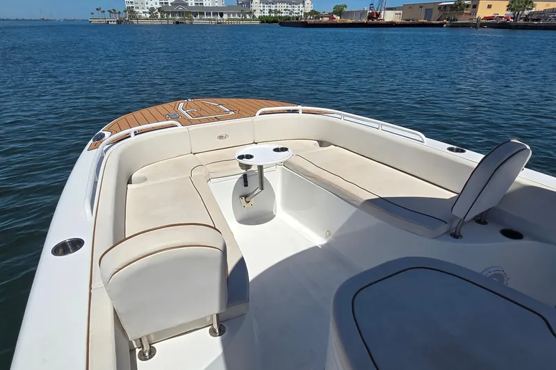 Slide: The Image of 2021 Sea Hunt Escape 27 boat interior with seating and table on calm water. - 5