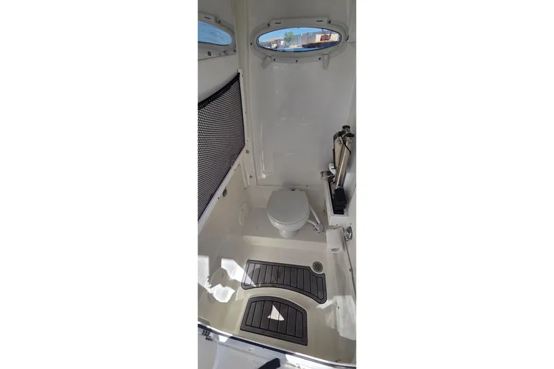 Slide: The Image of Interior of 2021 Sea Hunt Escape 27 boat bathroom with toilet and window. - 6