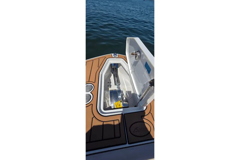 Slide: The Image of Open hatch on 2021 Sea Hunt Escape 27 boat, revealing storage compartment. - 7