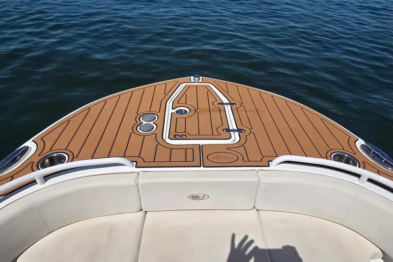 Slide: The Image of Bow view of 2021 Sea Hunt Escape 27 boat with teak deck and ocean backdrop. - 8