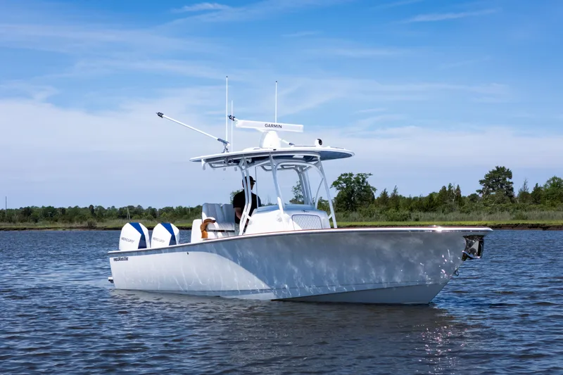 Slide: The Image of Valhalla Boatworks V-29 Hybrid 2027 cruising on a serene lake under a clear sky. - 2