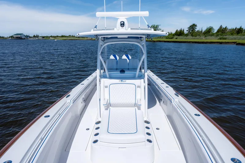 Slide: The Image of Valhalla Boatworks V-29 Hybrid 2027 on calm water, showcasing sleek design and seating. - 20