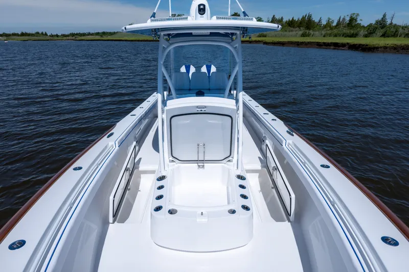 Slide: The Image of Valhalla Boatworks V-29 Hybrid 2027, sleek design on calm water, showcasing spacious deck. - 21