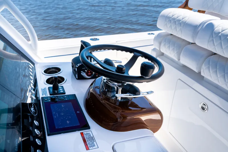 Slide: The Image of Steering console of 2027 Valhalla Boatworks V-29 Hybrid, featuring modern controls and luxurious seating. - 28