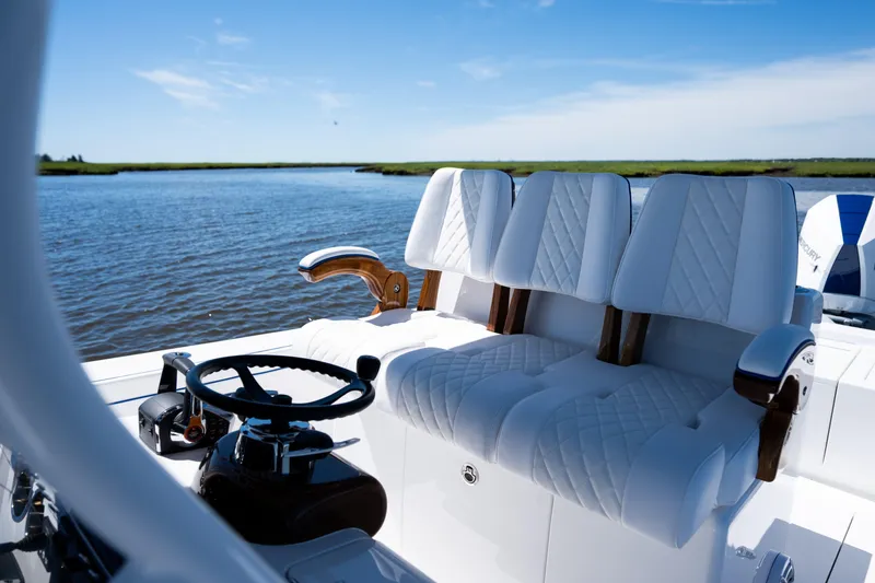 Slide: The Image of 2027 Valhalla Boatworks V-29 Hybrid with luxurious seating on a serene waterway. - 33