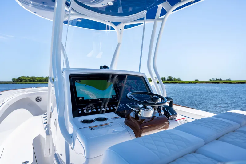 Slide: The Image of 2027 Valhalla Boatworks V-29 Hybrid dashboard with navigation screen, steering wheel, and plush seating. - 35