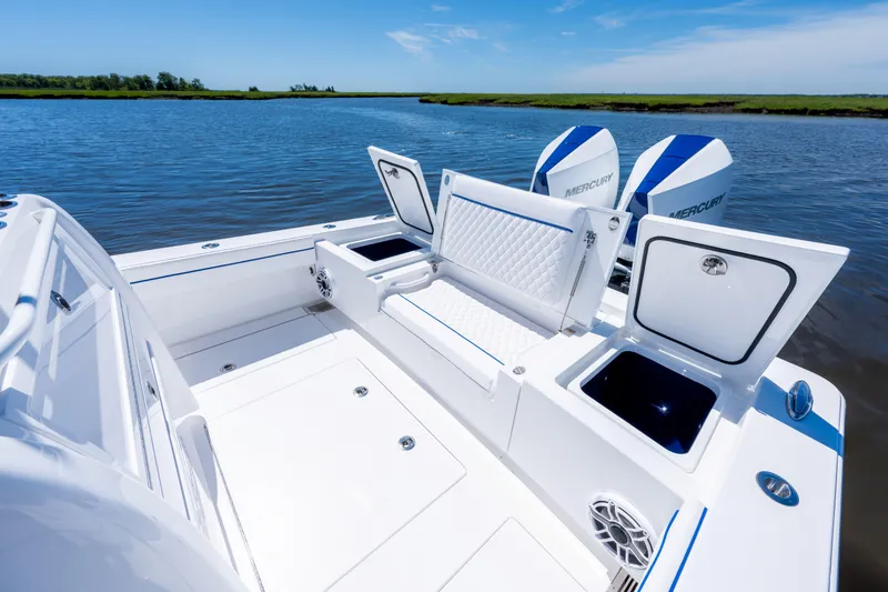 Slide: The Image of 2027 Valhalla Boatworks V-29 Hybrid with open storage compartments on a calm waterway. - 36