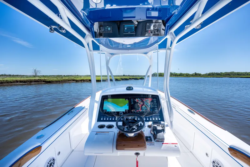 Slide: The Image of 2027 Valhalla Boatworks V-29 Hybrid cockpit with advanced navigation system on calm water. - 43