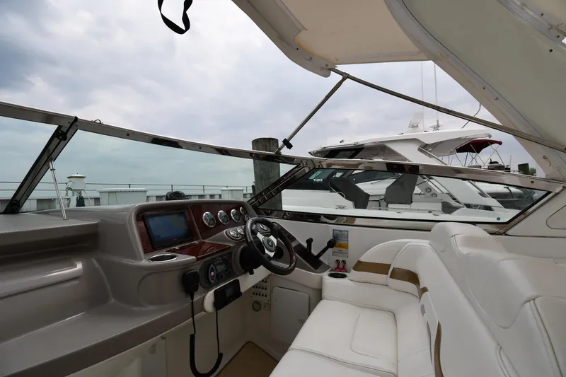 Slide: The Image of 2004 Formula 330 Sun Sport boat interior with steering wheel and dashboard controls. - 10