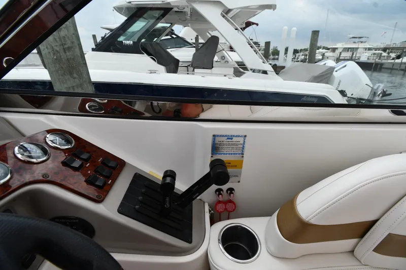Slide: The Image of Interior view of a 2004 Formula 330 Sun Sport boat cockpit with controls and seating. - 12