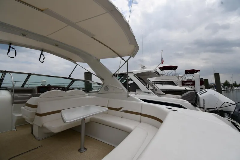 Slide: The Image of 2004 Formula 330 Sun Sport yacht interior with seating and table at marina. - 16