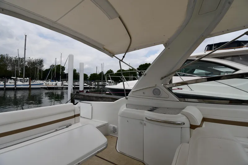 Slide: The Image of 2004 Formula 330 Sun Sport boat interior at marina with sailboats in background. - 19