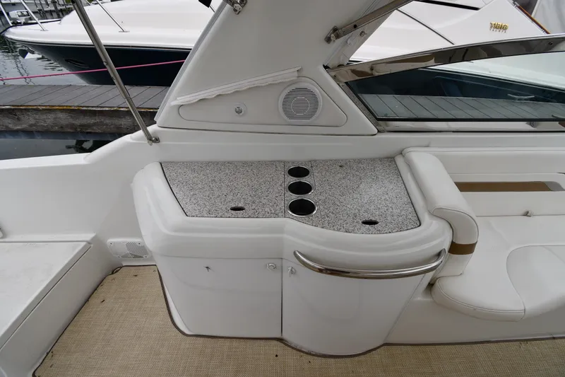 Slide: The Image of 2004 Formula 330 Sun Sport boat interior with cup holders and seating area. - 20