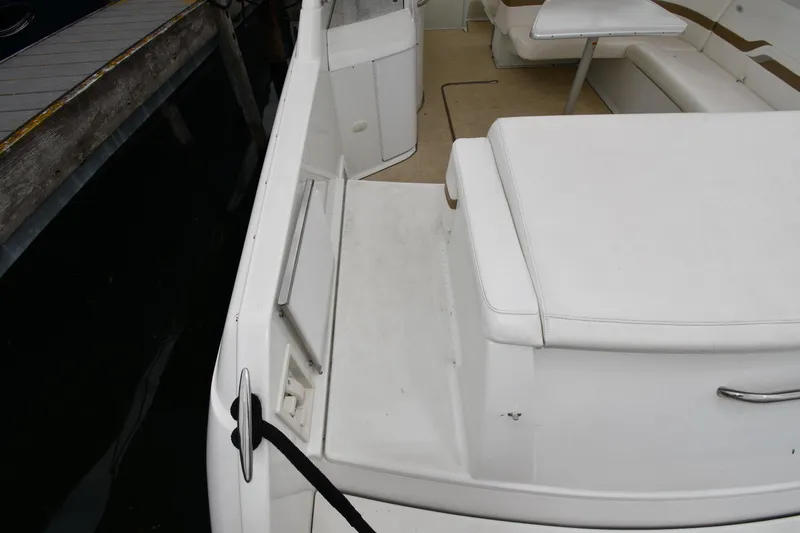 Slide: The Image of 2004 Formula 330 Sun Sport boat interior with white seating and table. - 23