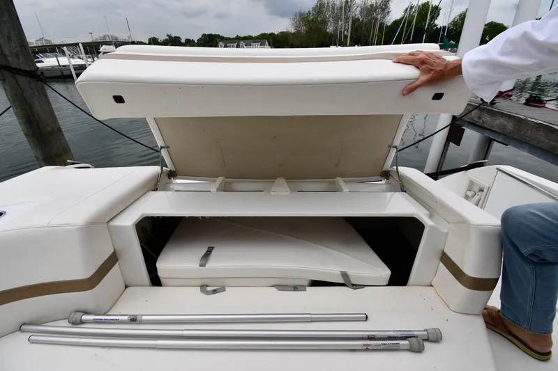 Slide: The Image of Open storage compartment on a 2004 Formula 330 Sun Sport boat at a marina. - 24