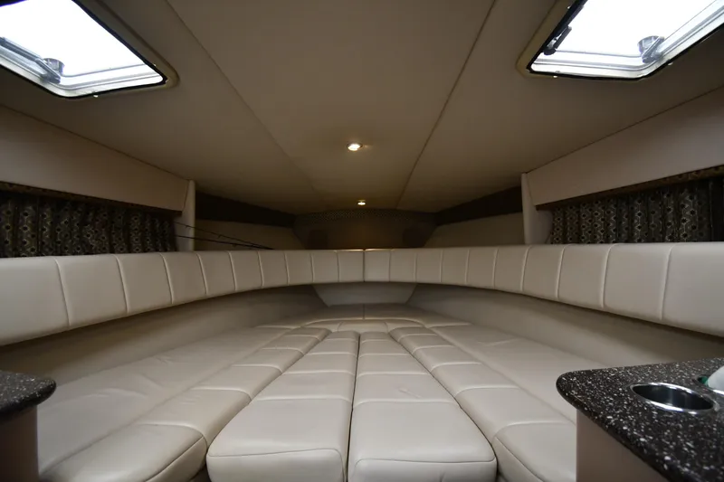 Slide: The Image of 2004 Formula 330 Sun Sport cabin interior with beige seating and overhead lighting. - 26