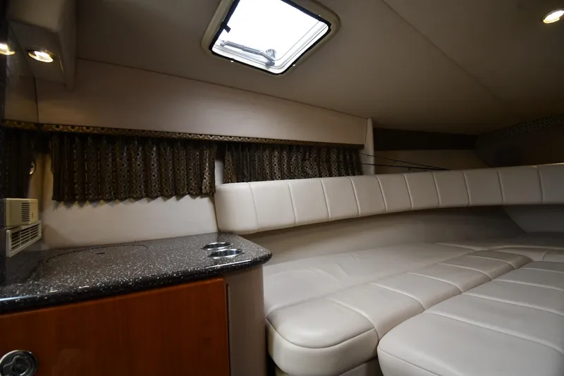 Slide: The Image of Interior of 2004 Formula 330 Sun Sport boat with plush seating and compact kitchenette. - 28
