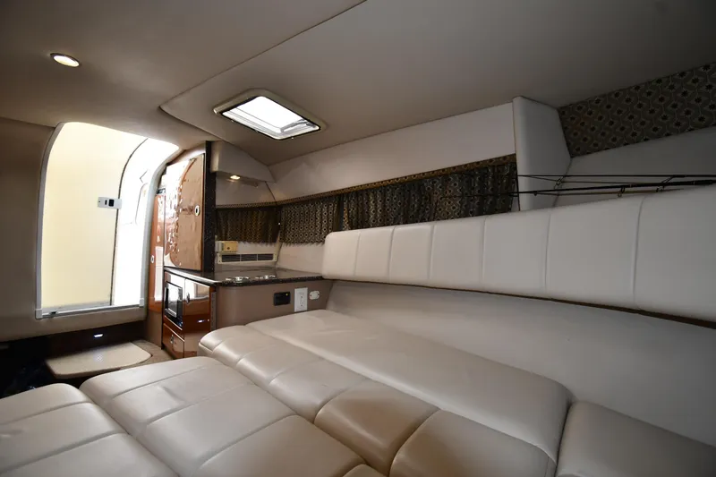 Slide: The Image of Interior of 2004 Formula 330 Sun Sport boat with white seating and kitchenette. - 29