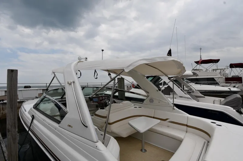 Slide: The Image of 2004 Formula 330 Sun Sport boat docked under cloudy skies. - 3