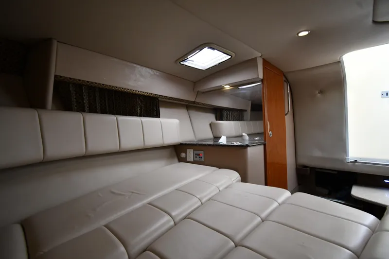 Slide: The Image of Interior of 2004 Formula 330 Sun Sport boat with beige seating and compact kitchenette. - 30