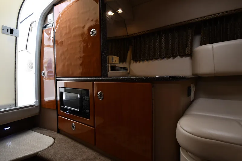 Slide: The Image of Interior of a 2004 Formula 330 Sun Sport boat with microwave and seating area. - 31