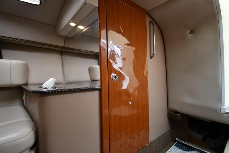 Slide: The Image of Interior of 2004 Formula 330 Sun Sport boat with wood door and seating area. - 32