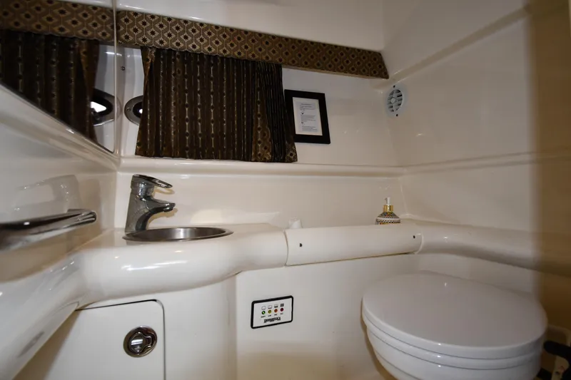 Slide: The Image of 2004 Formula 330 Sun Sport bathroom with sink, toilet, and decorative curtains. - 34