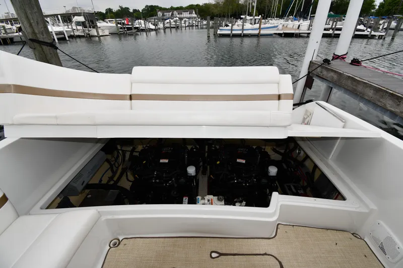 Slide: The Image of 2004 Formula 330 Sun Sport boat engine compartment open at marina. - 38