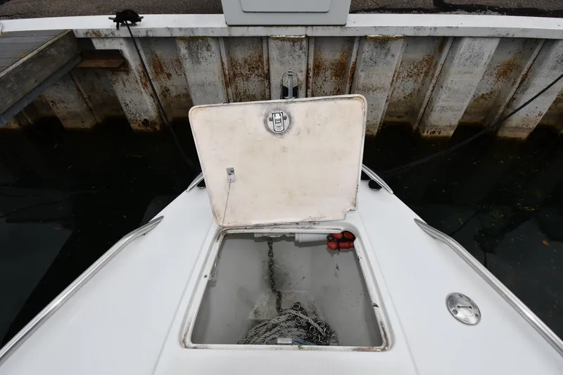 Slide: The Image of Open anchor compartment on 2004 Formula 330 Sun Sport boat at dock. - 5