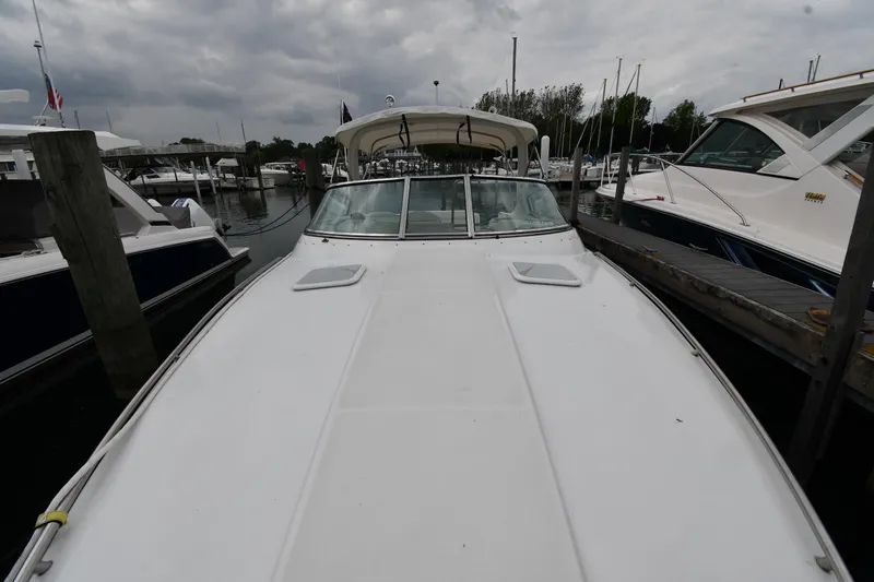 Slide: The Image of 2004 Formula 330 Sun Sport boat docked at marina under cloudy sky. - 6