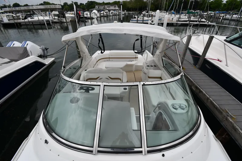 Slide: The Image of 2004 Formula 330 Sun Sport boat docked at a marina, featuring a sleek design and spacious seating. - 7