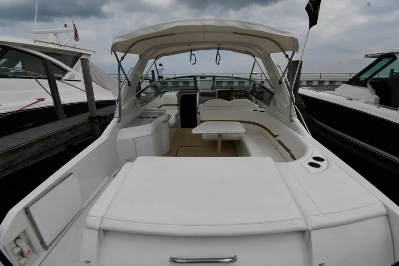 Slide: The Image of 2004 Formula 330 Sun Sport boat docked, featuring spacious seating and canopy. - 8