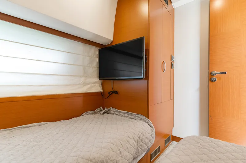 Slide: The Image of Cozy cabin interior of 2017 Prestige 500 yacht with twin beds and wall-mounted TV. - 10