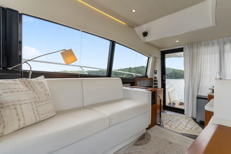 Slide: The Image of Luxurious interior of a 2017 Prestige 500 yacht with white seating and scenic window views. - 14