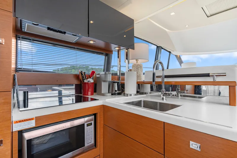 Slide: The Image of Modern kitchen interior on a 2017 Prestige 500 yacht, featuring sleek cabinetry and appliances. - 19