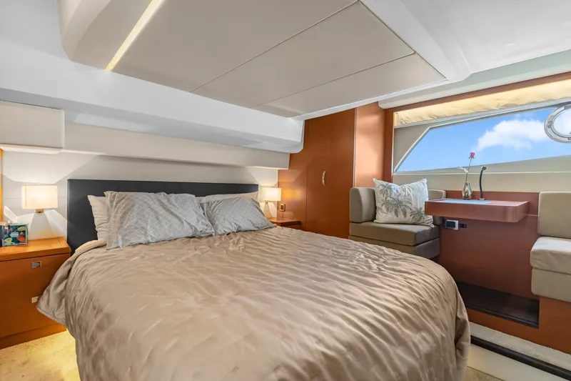 Slide: The Image of Luxurious bedroom interior of 2017 Prestige 500 yacht with elegant furnishings and large window view. - 24