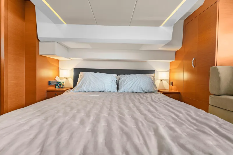 Slide: The Image of Luxurious cabin interior of 2017 Prestige 500 yacht with cozy bedding and ambient lighting. - 26