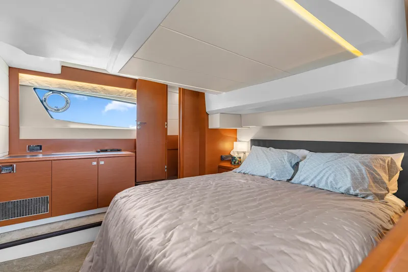Slide: The Image of Luxurious cabin interior of a 2017 Prestige 500 yacht with elegant bedding and wooden accents. - 27
