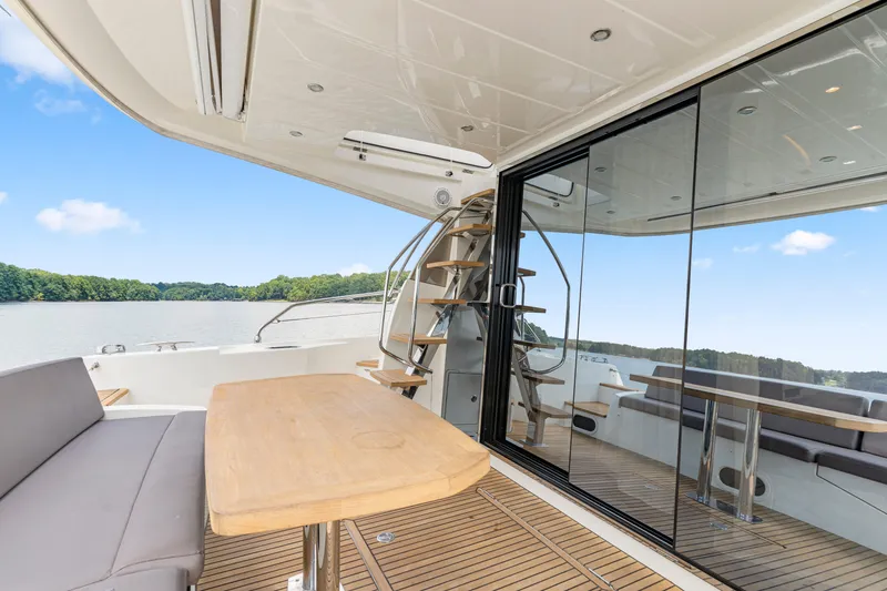 Slide: The Image of Luxurious 2017 Prestige 500 yacht with spacious deck, elegant seating, and scenic water views. - 28