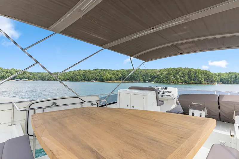 Slide: The Image of Luxury 2017 Prestige 500 yacht with spacious deck and scenic lake view. - 32