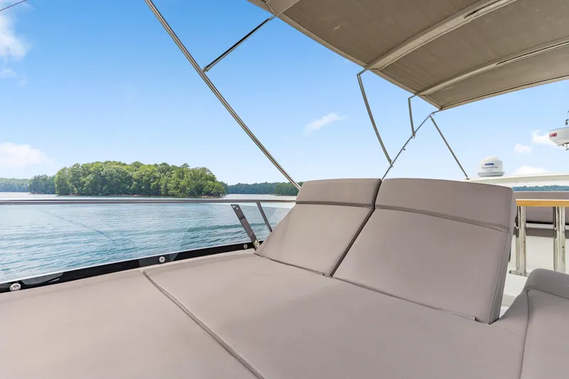Slide: The Image of Luxurious 2017 Prestige 500 yacht with sunbed, overlooking serene water and lush island. - 33