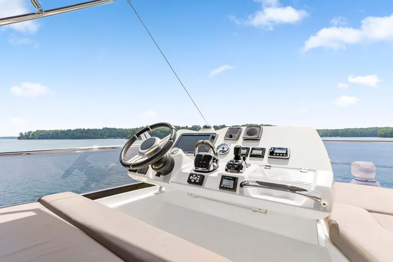 Slide: The Image of Cockpit of 2017 Prestige 500 yacht with steering wheel and control panel on open water. - 35