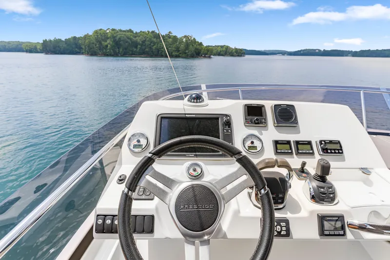 Slide: The Image of Helm of 2017 Prestige 500 yacht with scenic lake view. - 38